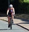 Female competitor on cycling stage of triathlon.