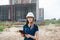 Female construction engineer. Architect with a tablet computer at a construction site. Young Woman look in camera