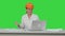 Female construction specialist in hardhat have online video chat with friend on a Green Screen, Chroma Key.