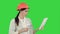 Female construction specialist in hardhat having a video call via tablet on a Green Screen, Chroma Key