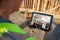 Female Construction Worker Reviewing Kitchen on Computer Pad