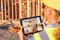 Female Construction Worker Reviewing Kitchen on Computer Pad