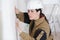 Female construction worker smoothing wall surface