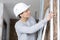 female contractor examining wall insulation