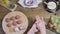 female cook cooks meatballs, dipping balls of minced meat in flour on a wooden table with all the ingredients