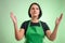 Female cook with green apron and black t-shirt with open arms looking up