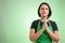 Female cook with green apron and black t-shirt praying