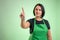 Female cook with green apron and black t-shirt presses a virtual button