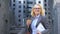 Female corporate worker breathing free holding coffee cup and work documents