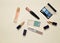 Female cosmetics for make-up layout on a pastel background. Cosmetic shadows, make-up brush, eyeshadow lipstick, perfume bottle.