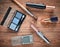 Female cosmetics for make-up layout on a wooden table. Cosmetic shadows, make-up brush, eyeshadow lipstick. Flat lay, top view