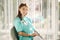 Female cosmetologist in green robe. Beautiful doctor in beauty salon