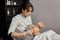 A female cosmetologist makes an alginate face mask for a young female client.