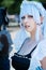 Female cosplayer in a vintage blue dress with blue hair