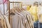 Female cotton clothes in neutral colors tone hanging on clothing rack for sale in boutique fashion store