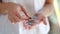 Female counting coins in her hands close up.