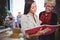 Female coworkers smiling while discussing over file