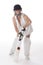 Female cricketer in a white dress with bat, pads, bat and safety helmet.