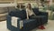 Female customer choosing sofa in shopping center. Woman sitting on couch imagining her new home architectural