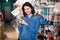 Female customer examining various painting brushes