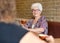 Female Customer Having Coffee In Cafe