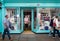 Female customer leaving Moshulu shoe shop with face mask on in Wells, Somerset, UK