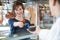 Female Customer Paying In Butchers Shop Using Credit Card