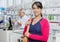 Female Customer Smiling While Chemist Working In Pharmacy