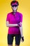 Female Cycling Ideas. Portrait of Positive Female Road Cyclist in Professional Sport Outfit Posing Against Yellow Background