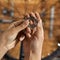 Female cycling master hands holding bike spoke key