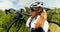 Female cyclist carrying bicycle on countryside road 4k