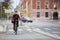 Female Cyclist With Courier Delivery Bag On Street