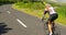 Female cyclist cycling on a countryside road 4k