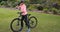 Female cyclist drinking water in park