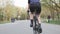 Female cyclist legs pedalling a bicycle. Back follow shot. Leg muscles on bicycle. Cycling concept. Slow motion