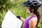 Female cyclist looking at map