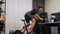 Female cyclist is pedaling out of saddle on stationary bike trainer. Indoor cycling
