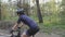 Female cyclist riding bicycle in park. Close up side view follow shot. Cycling concept