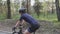 Female cyclist riding bicycle in park. Close up side view follow shot. Cycling concept. Slow motion