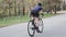 Female cyclist sprinting out of the saddle. Cycling training concept. Uphill cycling ride