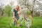 Female cyclist with vintage white bicycle in spring garden