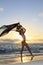 Female dancer standing by the ocean