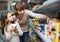 Female with daughter choosing canned goods in food store