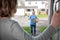 Female Delivery Driver Leaving Package Outside House For Safety Observing Social Distancing During Coronavirus Pandemic