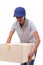 Female delivery staff carrying heavy carton box
