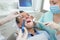 Female dentis working with patient at dental clinic office