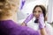 Female Dentist Adjusting Patient\'S Face On Xray Machine