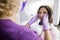 Female Dentist Adjusting Woman\'s Face On Xray Machine