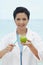Female dentist brushing green apple with toothbrush. Conceptual image