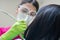 Female dentist cleaning teeth of patient